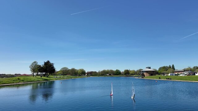 Gosport Hampshire England UK. 19.04.2026. Video. A picturesque rural landscape featuring model yachts race on a pond in Walpole Park Gosport UK