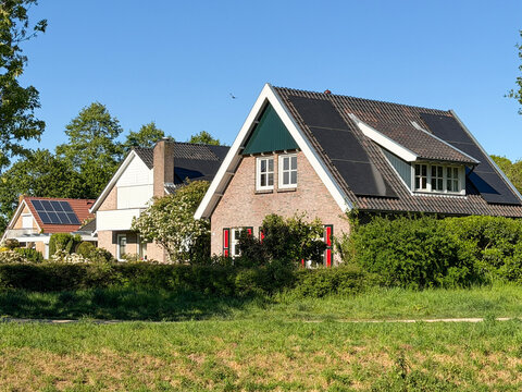 Solar panels on houses. European residential neighborhood with rooftop solar panels and sustainable living