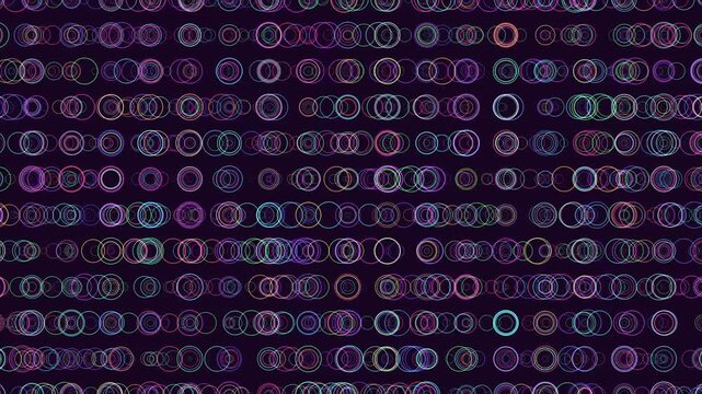 Abstract footage of colorful neon bokeh rings and glowing circle outlines drifting on a dark background, ideal for tech, music, party, and futuristic motion design