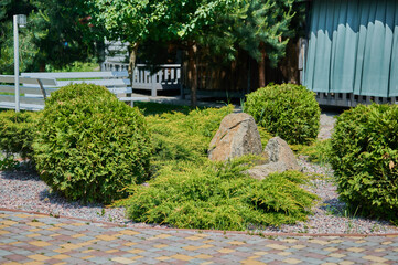 Naklejka premium Tranquil garden scene with greenery and stones
