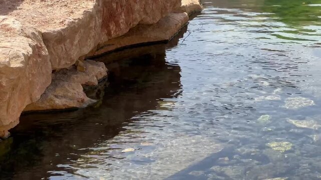 Crystal Clear Water Flowing Over Stone Steps in Wadi Hanifa