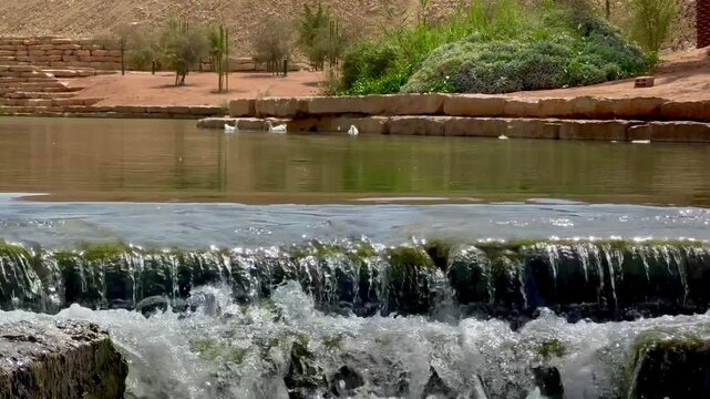 Crystal Clear Water Flowing Over Stone Steps in Wadi Hanifa