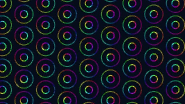Abstract footage of multicolor neon concentric circles and glowing rings arranged in a seamless grid on dark background, ideal for tech, music, and modern design