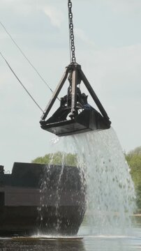Industrial dredging bucket releasing water