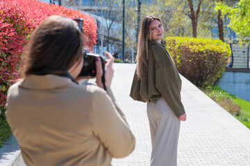 Fototapeta premium Young model photographed by female photographer in the city