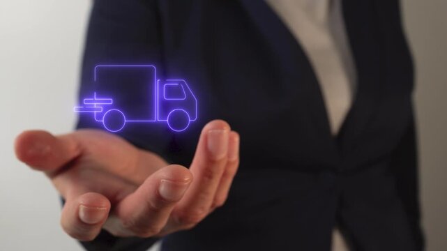 Woman's hand holding electric delivery truck icon	
