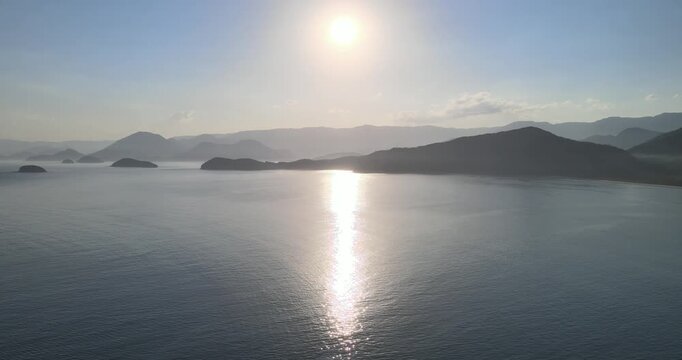 Aerial view of Picinguaba Bay and a beautiful sunset surrounded by rainforest, Ubatuba coast.. Paisagem a&eacute;rea da ba&iacute;a de Picinguaba e um belo p&ocirc;r do sol cercada por floresta tropical, costa de Ubatuba