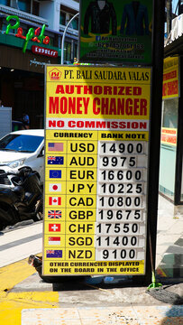 Currency exchange in Kuta, Bali. Currency exchange rate in Bali in 2024.Money exchange rates displayed at a currency exchange location in Bali during a sunny day
