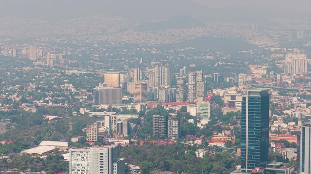 Aerial shot of south Mexico City skyline with smog and traffic