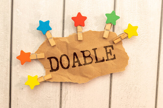 doable colorful word on the wooden background.