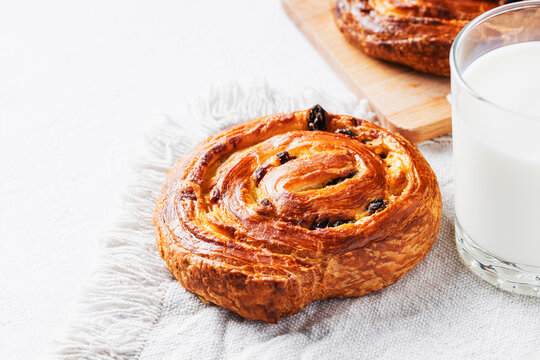 Raisin swirl Danish pastry with glass of milk for breakfast