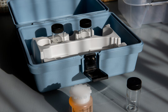 Portable water testing kit with sample vials and container