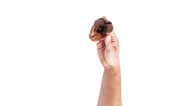 Chocolate cupcakes with cherry jam isolated on a white background. Chocolate muffin in hand.