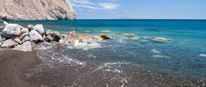 Perissa beach in Santorini - Greece. Beautiful seascape with rocks and cliff
