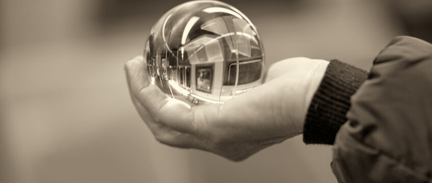 Woman hold a Crystal Ball with subway train reflection
