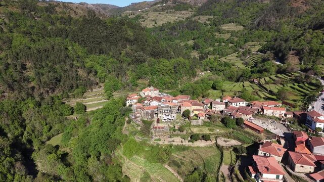 Sistelo village nestled in mountains with traditional stone houses and green terraced fields