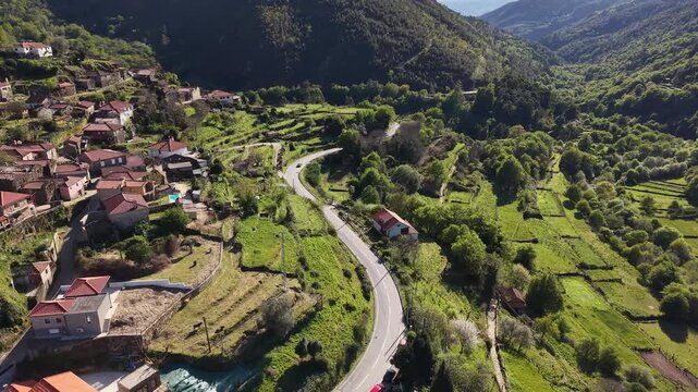 Sistelo village nestled in mountains with traditional stone houses and green terraced fields