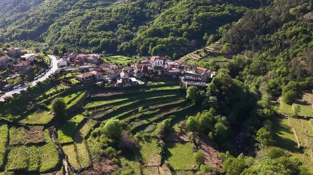 Sistelo village nestled in mountains with traditional stone houses and green terraced fields