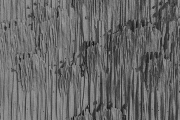 A detailed close-up of a weathered dark gray textured surface. © mod