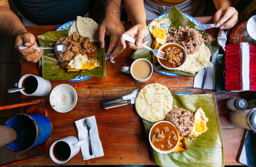 Family enjoying traditional central american breakfast on wooden table  in Costa Rica © Fabian Vargas