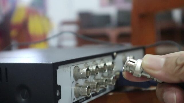 Disconnecting a BNC connector from a DVR port for a wired CCTV network