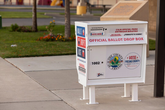 Mendota, California, USA - October 28, 2024: An official ballot dropbox stands on a sidewalk outside of city hall.