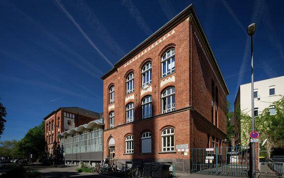 Cologne, Germany April 30 2026: The Zugweg elementary school in Cologne's Suedstadt. Historic red brick building with distinct round-arch windows under a clear blue sky
