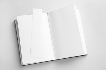 Naklejka premium Book with white bookmark on grey background, top view. Space for text