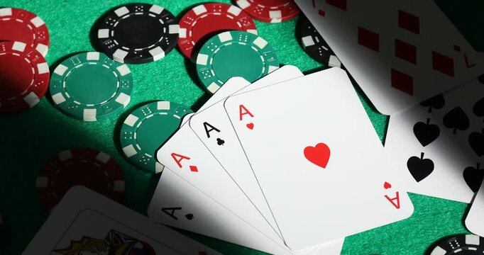Casino chips and playing cards on green table