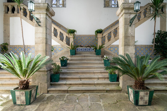 Tranquil interior courtyard of the Nossa Senhora do Carmo church in Guimares, with plants, tile, and stone steps