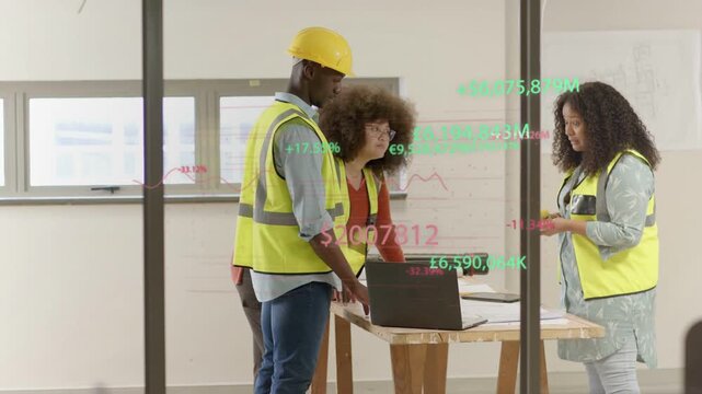 Construction team leaning over laptop and plans, animated charts appearing and guiding plan updates