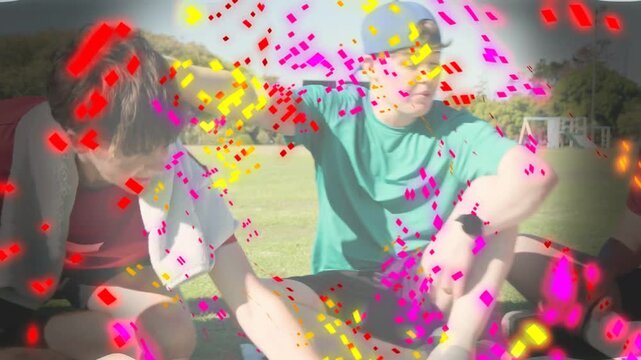 Green tee teen reaching, group gathering around phone with confetti filling frame for marketing