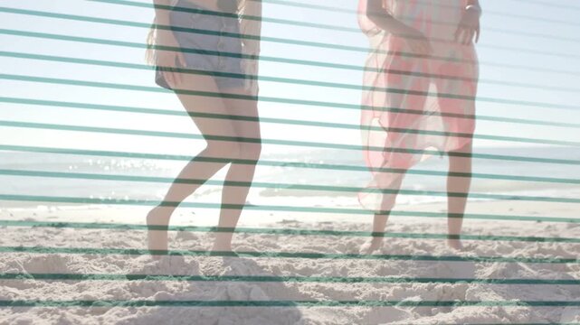 Friends playing, nudging soccer ball on beach, ball rolling in from left, sports stripe overlay