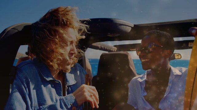 Man holding brown bottle speaking and sharing, woman smiling, sparkles overlaying coast travel
