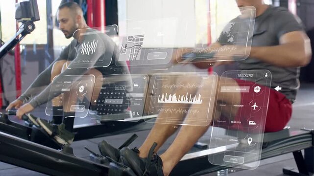 Two gym members beginning rowing as monitor updating, driving legs, pulling handle, HUD animating