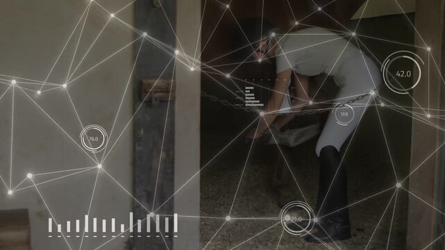 Male stable worker entering stall scooping bedding for horse care while HUD overlay tracks metrics