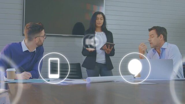 Lead tapping tablet cueing tech icons expanding then receding across table during business pitch