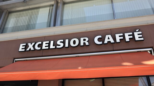 Excelsior Caffe storefront logo and orange awning at the Doutor Coffee group franchise location in a Japanese urban commercial district - Tokyo, Japan, October 14, 2024