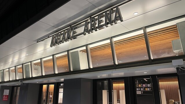 Ariake Arena multi-sport venue main entrance facade and metal exterior signage at the Koto city Olympic district under night evening lighting - Tokyo, Japan, October 15, 2024
