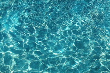 Fototapeta premium Rippling turquoise water, dappled sunlight creating shimmering patterns on surface