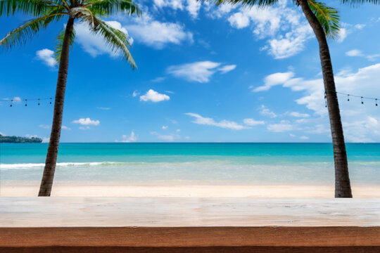 Wooden table with tropical beautiful white sand beach and blue sky background, Summer vacation concept and copy space