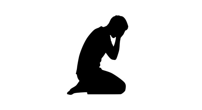 Silhouette of a depressed man kneeling and covering his face in despair