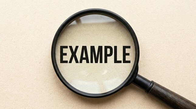 Close Up Magnifying Glass Over Word Example on Paper Background for Research Discovery Strategy and Business Case Study Concept