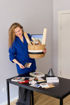Caucasian woman arranges marketing kits for media outreach