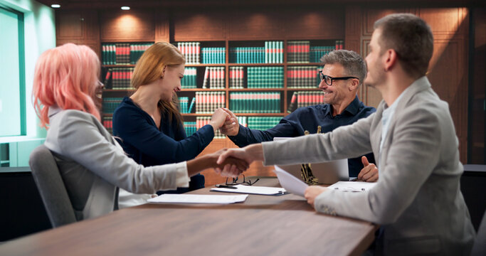 Corporate Lawyer And Team Shaking Hands