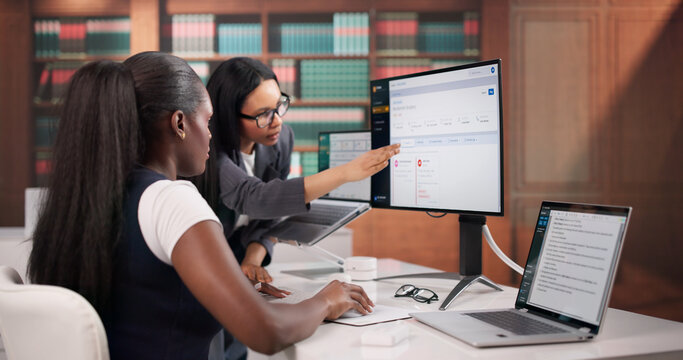 Lawyers Carefully Reviewing Contract Documents On Laptop