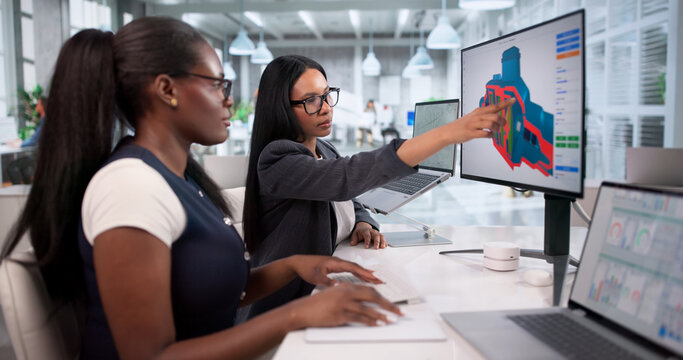 Young Engineers Collaborate On Laptop