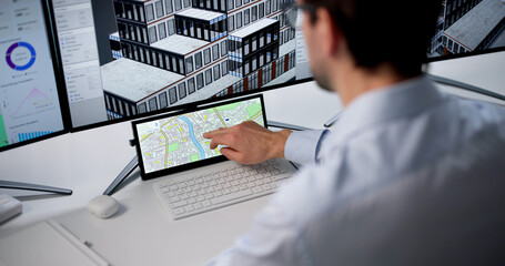 Naklejka premium Mature Man Uses Computer Software To Design Urban Map