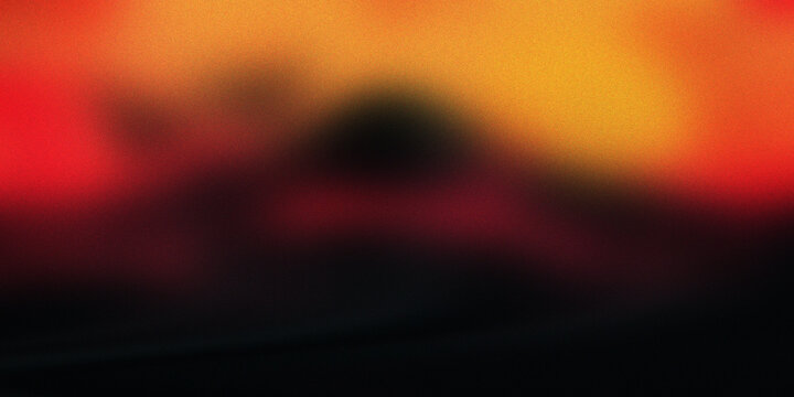 Blurred fire mountain abstract background with vibrant orange red and black tones creating dramatic volcanic heat landscape.