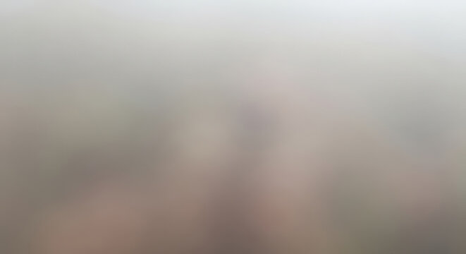 Blurred abstract sky with ethereal light streaks and soft gradient background